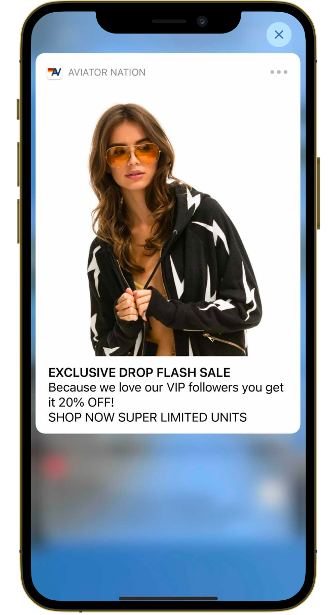 SMS text of woman wearing a hoodie. Text: “Exclusive drop flash sale” offering 20% off app orders.