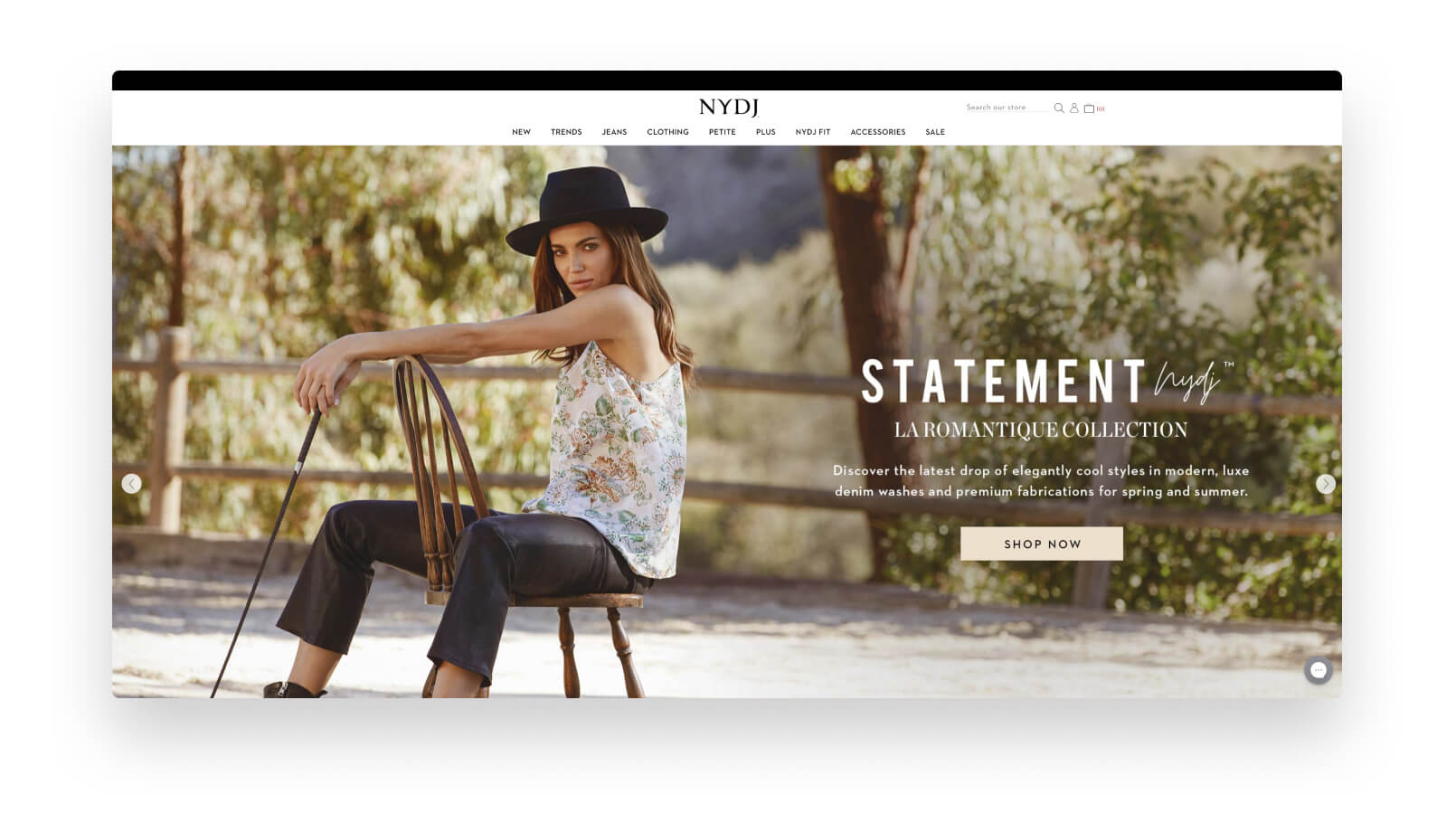The front page of the NYDJ online store with a female model sitting on a chair.