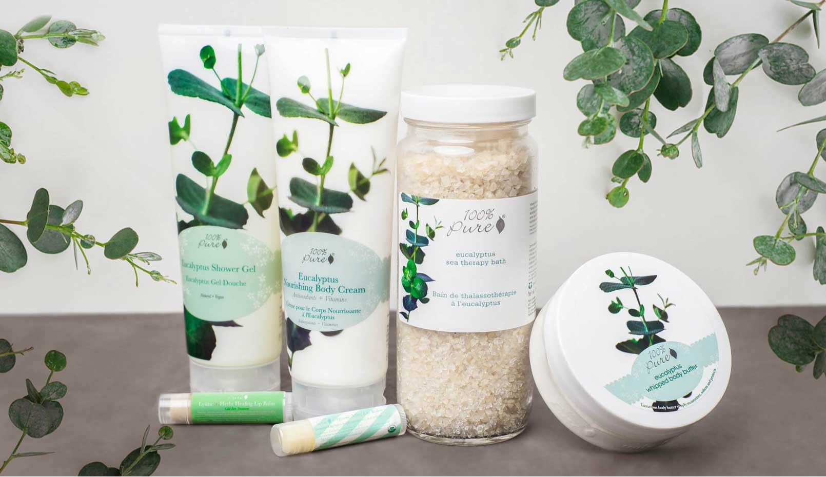 A lineup of skin care and bath products, such as shower gel, bath salts, and lip balms.