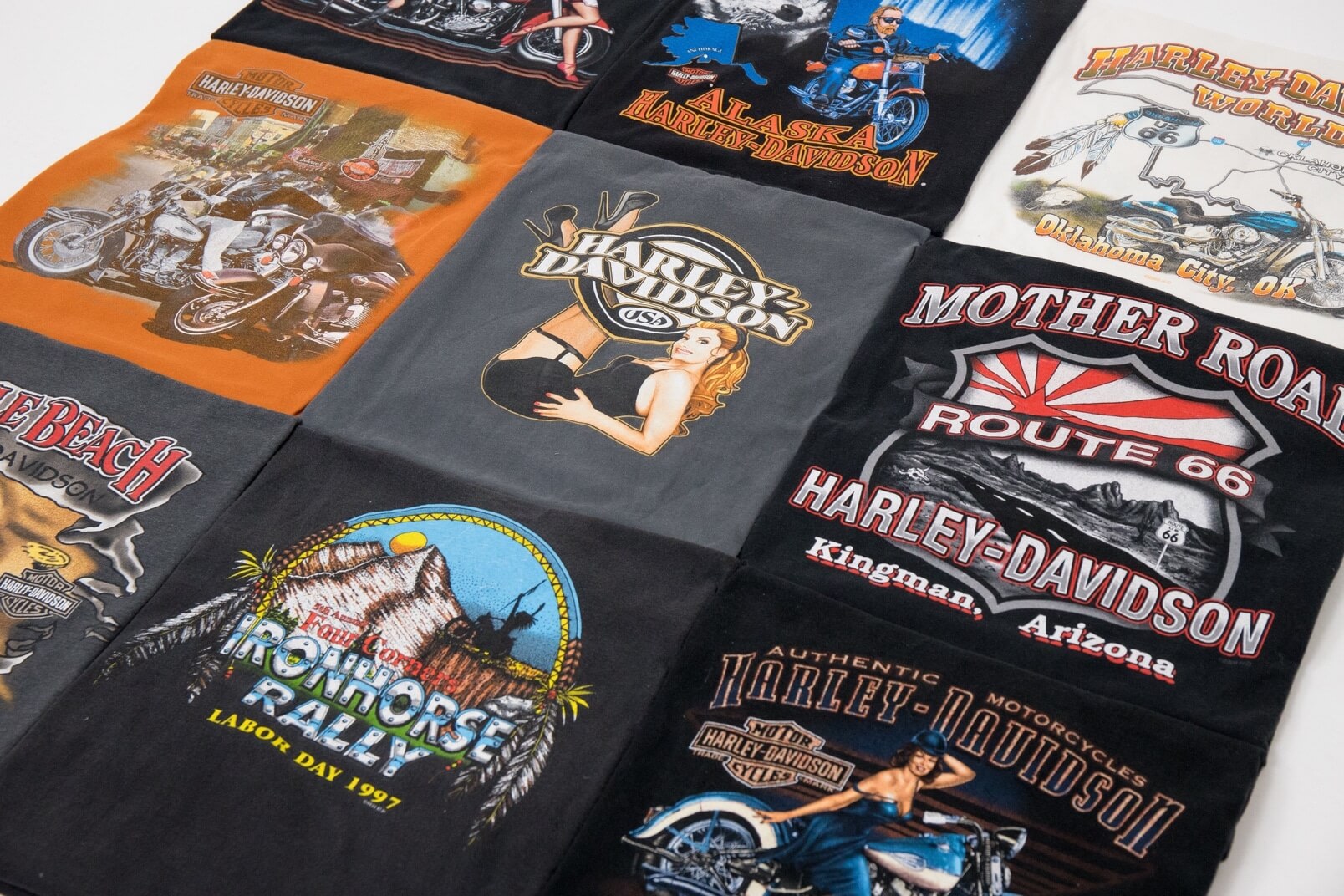 Three rows of three vintage T-shirts are arranged and laid flat in a grid.