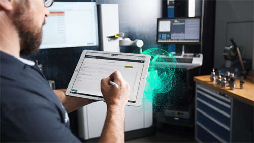 Engineer holding tablet to check equipment 