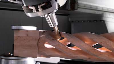 Industrial machinery carves wood