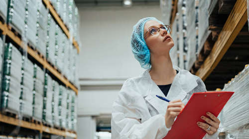 Employee inside cold storage of a pharmaceutical warehouse