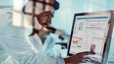 man looking at recipe on computer screen