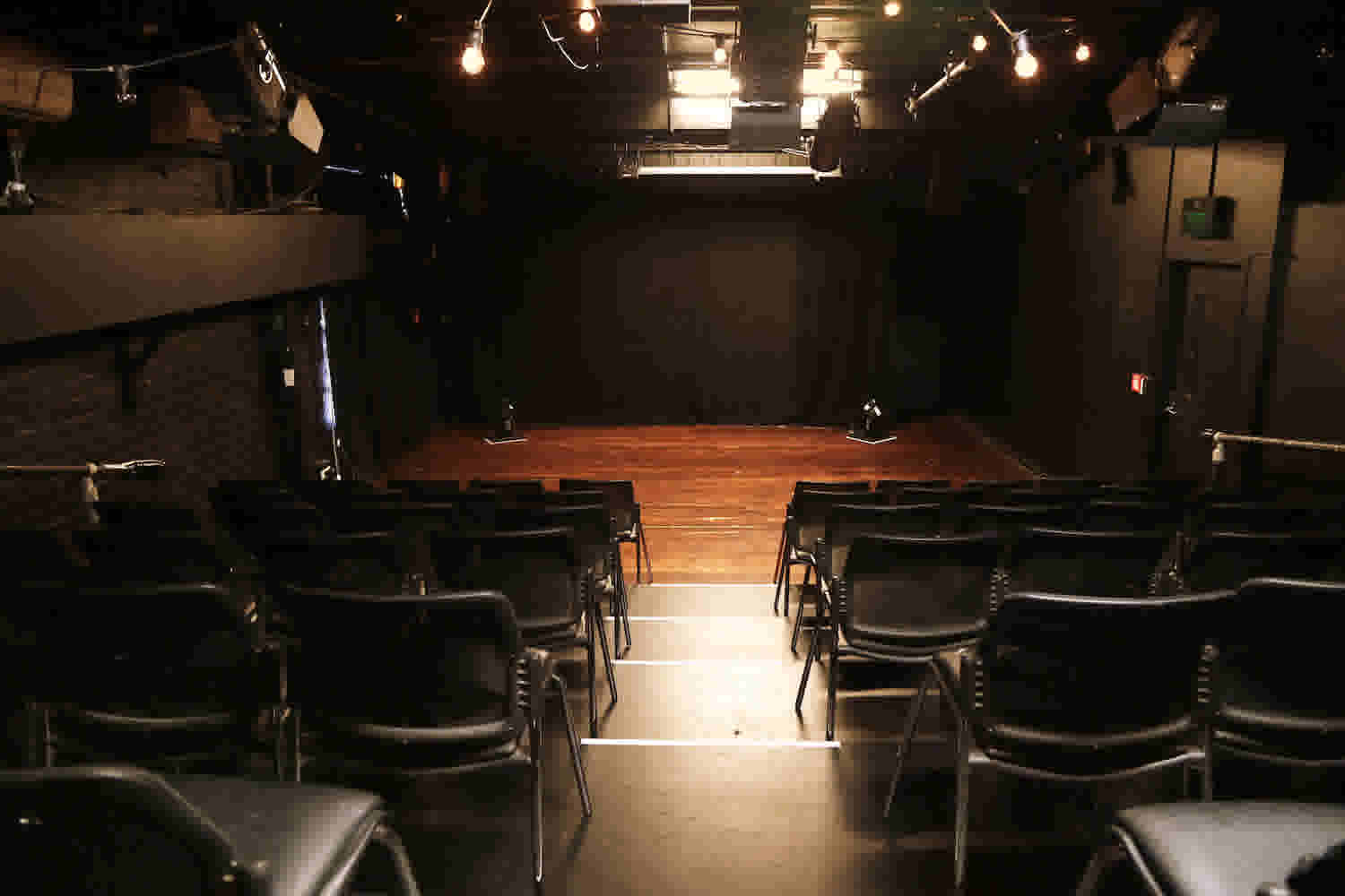 Basement Theatre's smaller Studio performance space showing the seating block and stage - taken from the back of the seating block. 