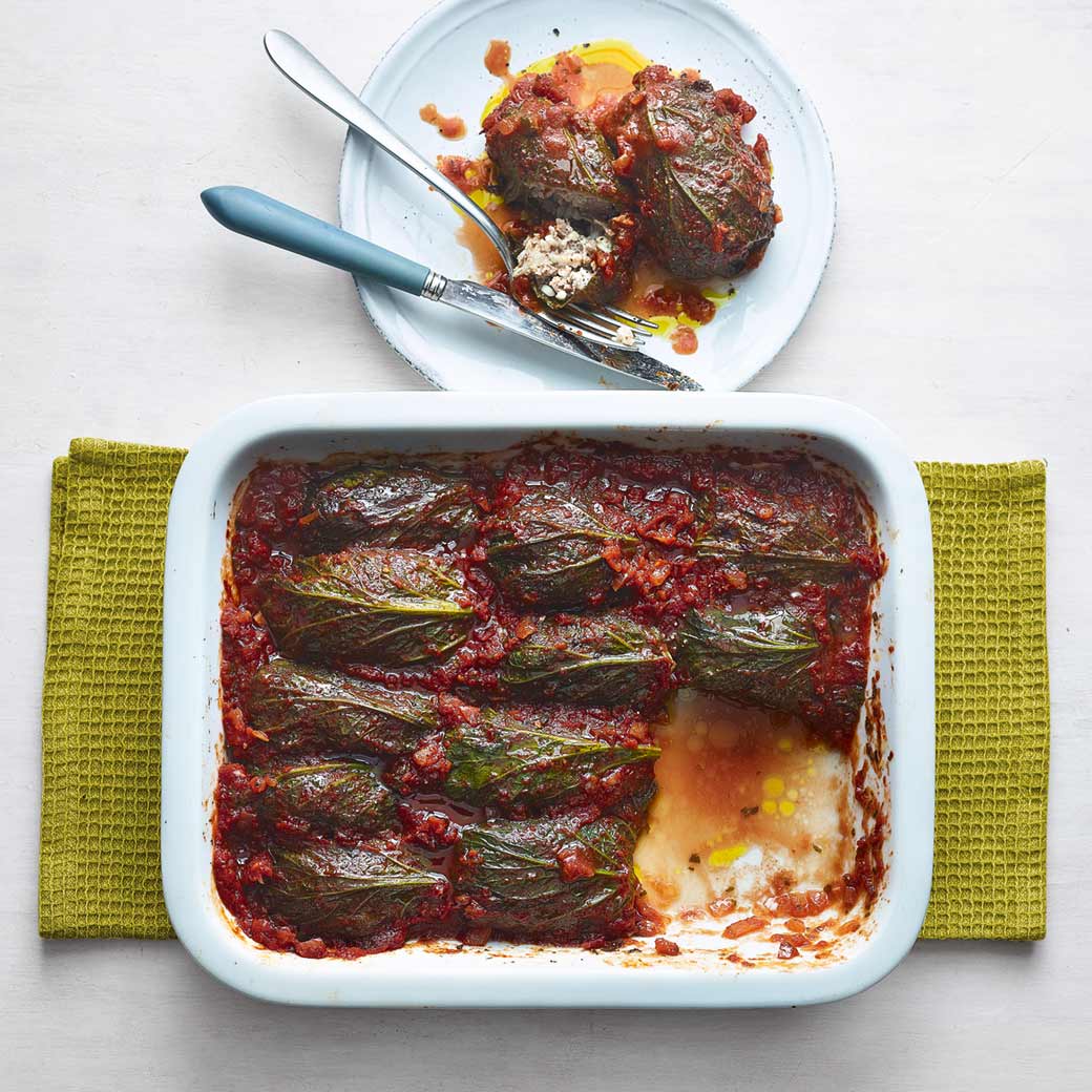 Lamb and feta stuffed kale dolma with tomato sauce and pilaf