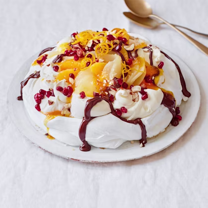 Chocolate Orange Pavlova Topped with Poached Pears, Hazelnuts and Pomegranate