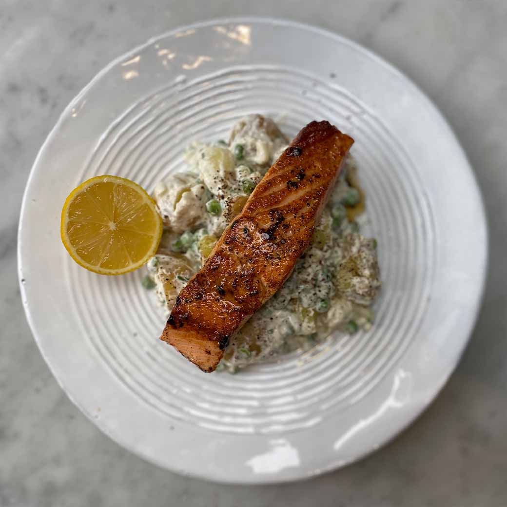 Pan-fried salmon with crushed potato and horseradish salad