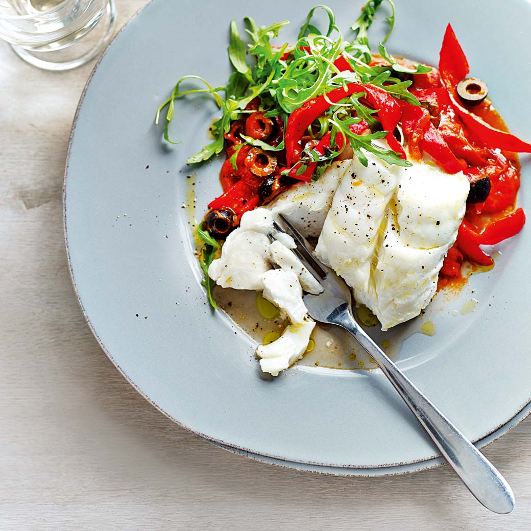 Oven-baked cod loin with pepper, tomato and olive sauce