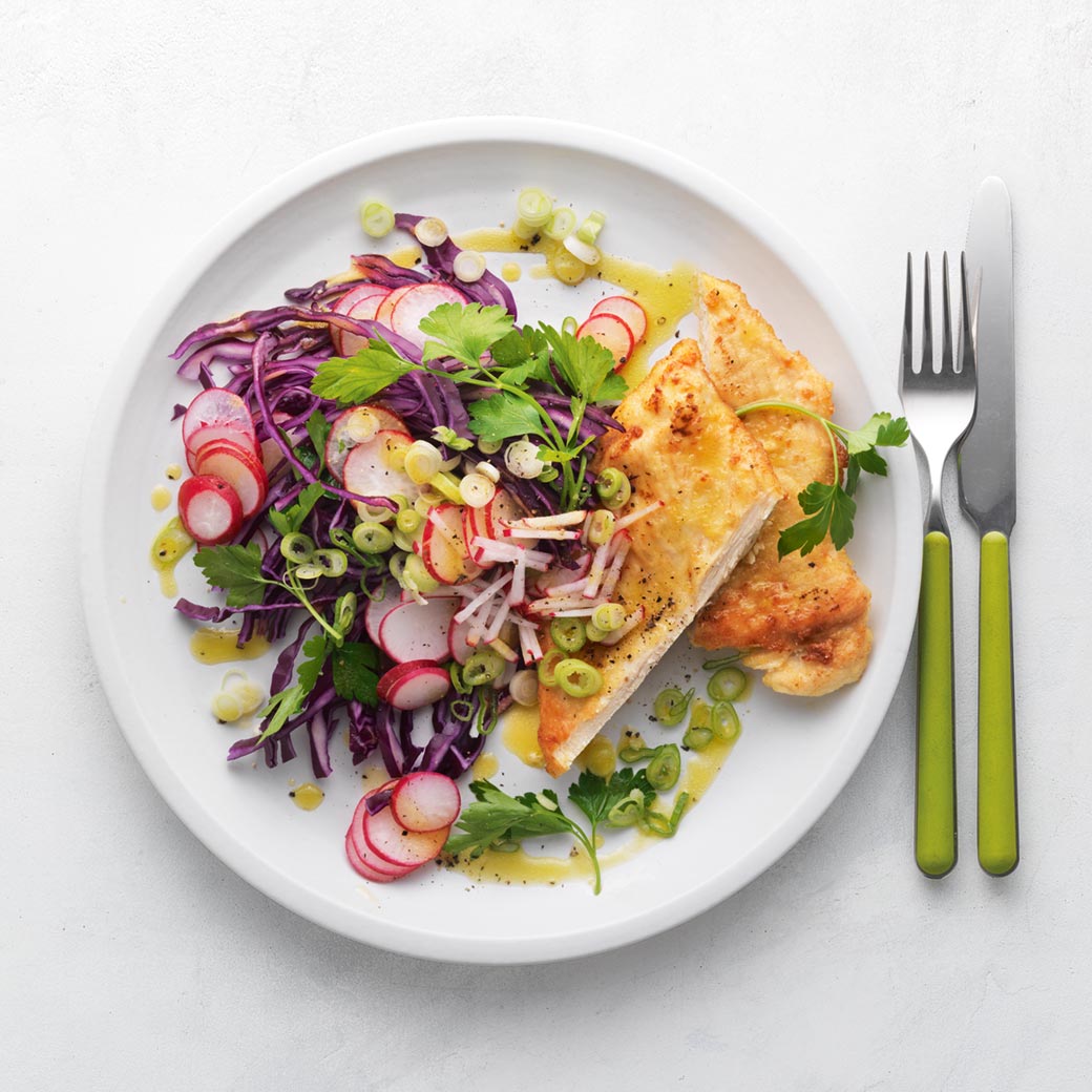Pan-fried chicken breast with red cabbage and radish slaw