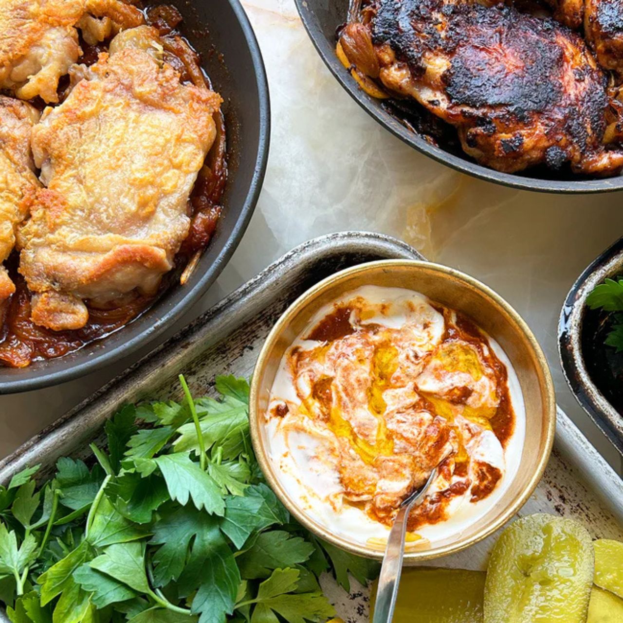 This spicy Libyan condiment really shines as a marinade on fatty meats. In this easy meal by Yotam Ottolenghi, chicken thighs are fried until crispy and stuffed into pittas with oily onions.