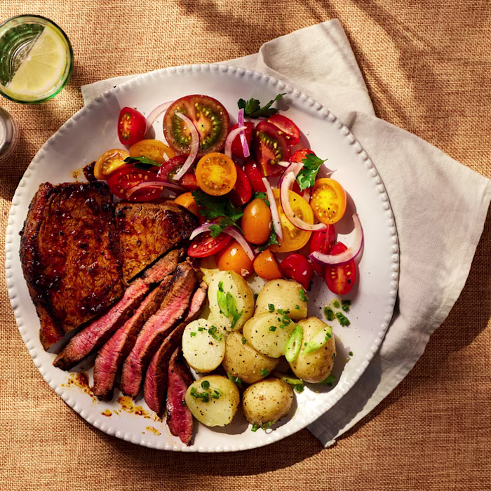 Steak, crushed new potatoes and tomato salad