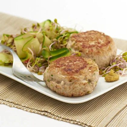 Tuna teriyaki burgers with red radish sprouts and cucumber ribbon salad