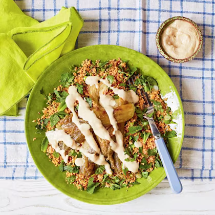 Grilled aubergines with tahini and roasted garlic sauce and harissa couscous