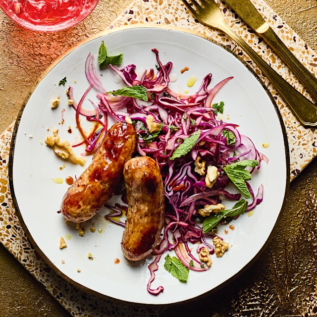 Pomegranate-glazed Sausages with Red Cabbage Slaw