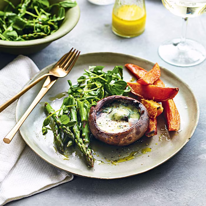 Mushroom steaks with blue cheese, sweet potato wedges, and asparagus and pea shoot salad