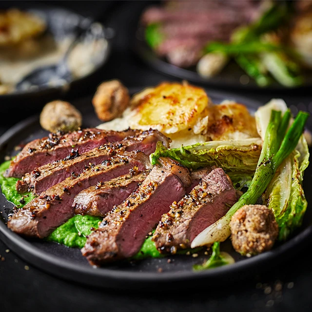 Grilled Beef Sirloin with Pommes Dauphinoise, Pea Purée and Crispy Garlic Mushrooms