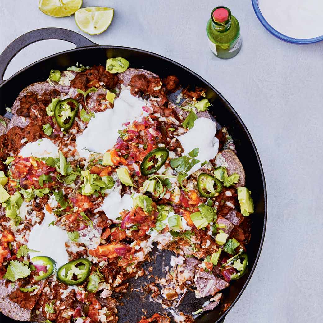 Refried beans with tortilla chips, chopped salad and burnt salsa