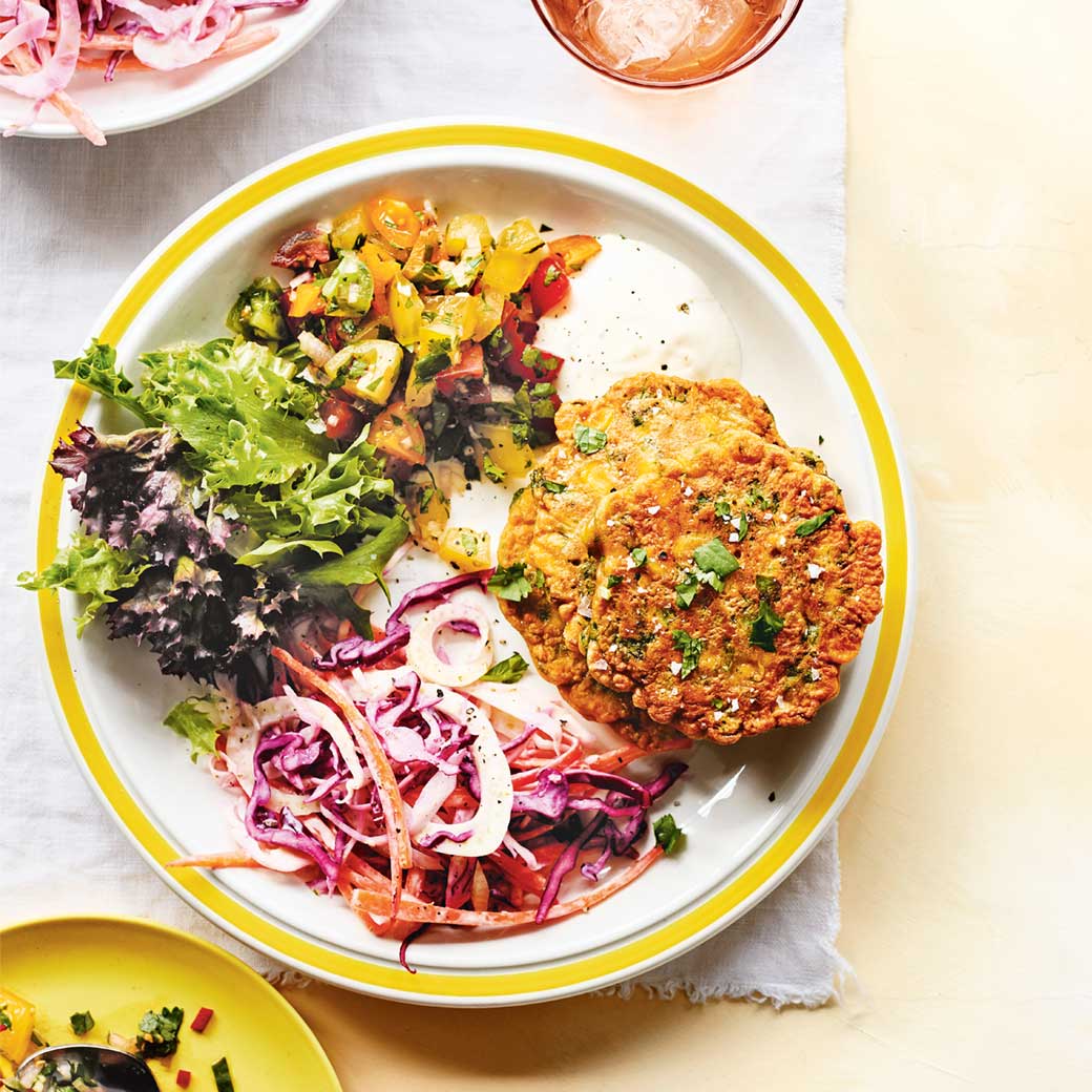 Sweetcorn fritter with summer tomato salsa, crunchy slaw and leaves