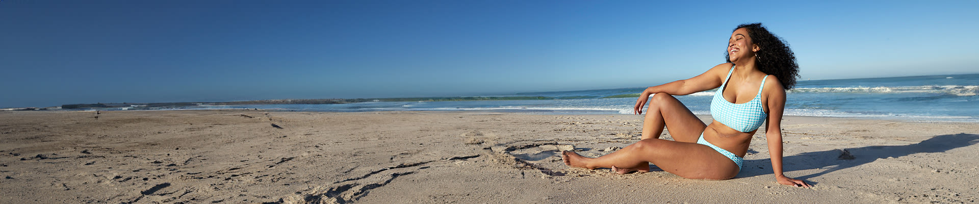 Woman enjoying the sun on the beach