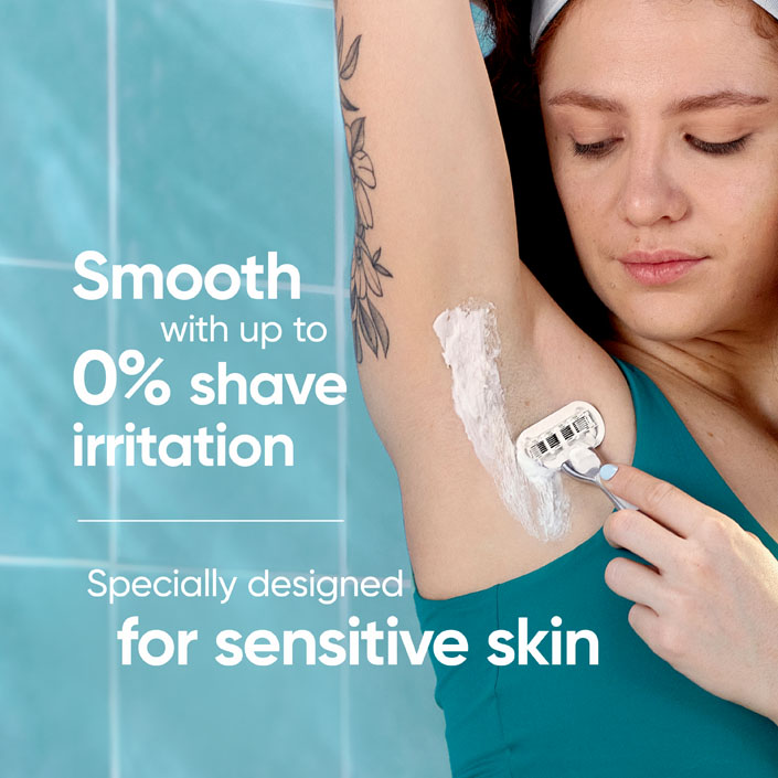 Young lady shaving her armpit in the bathroom, using Venus Extra Smooth Sensitive Razor.