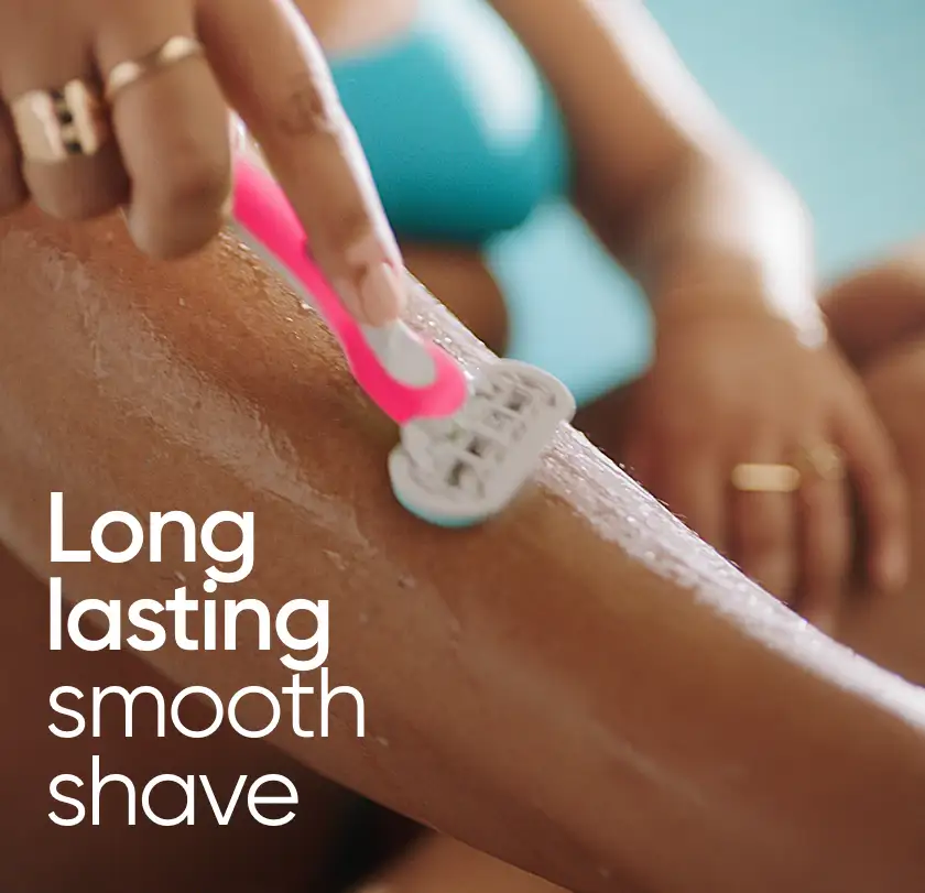 Shaving leg with a pink Gillette Venus disposable razor, featuring 'Long lasting smooth shave'.  
