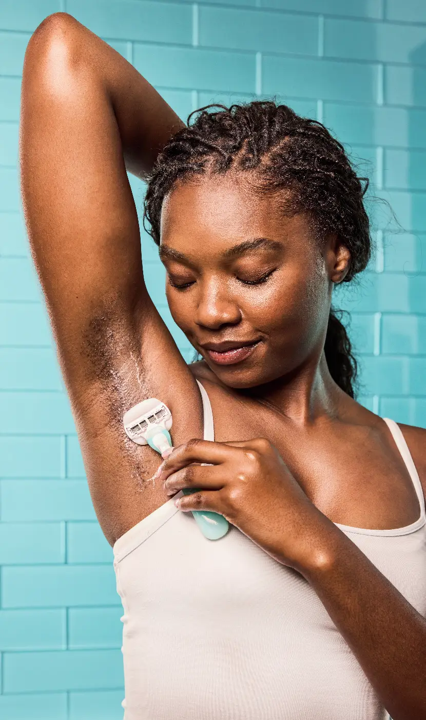 Woman shaving her leg with Gillette Venus razor in the bathroom