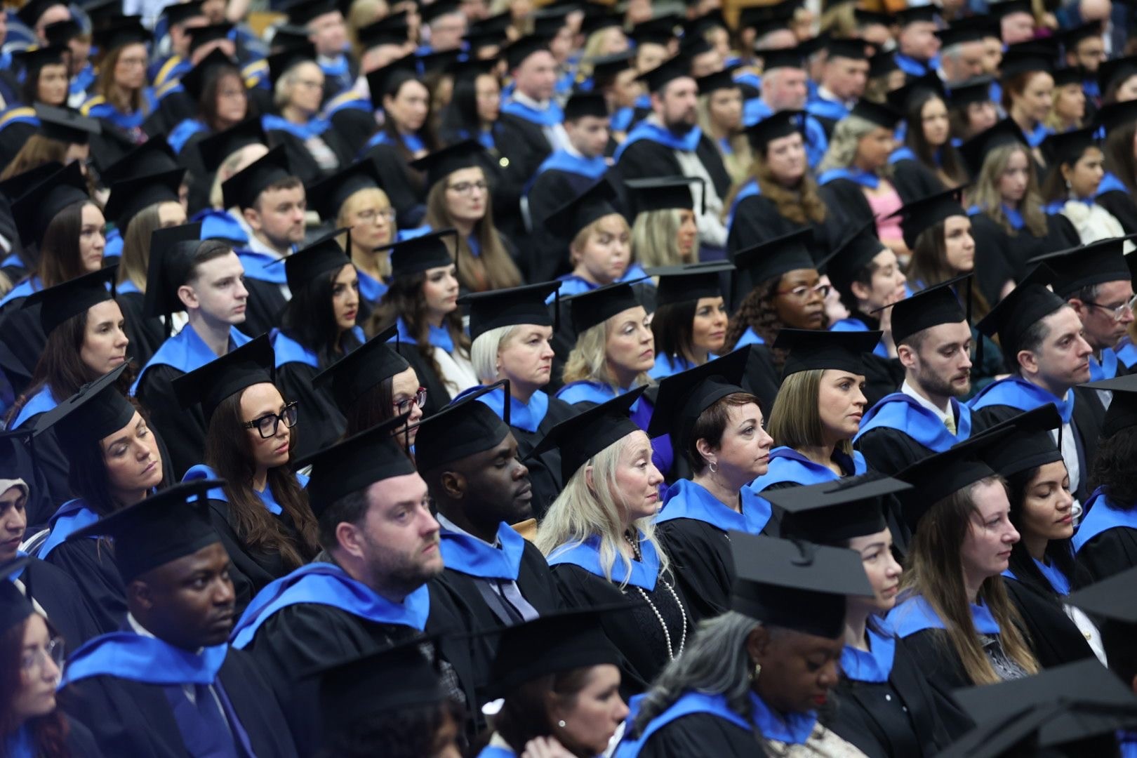 A group of graduates in graduation gowns and caps.
