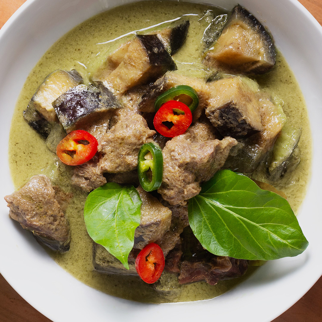 beef and aubergine curry with chillies and bayleaf garnish