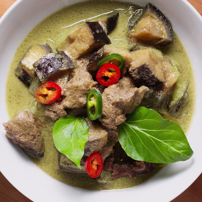 beef and aubergine curry with chillies and bayleaf garnish