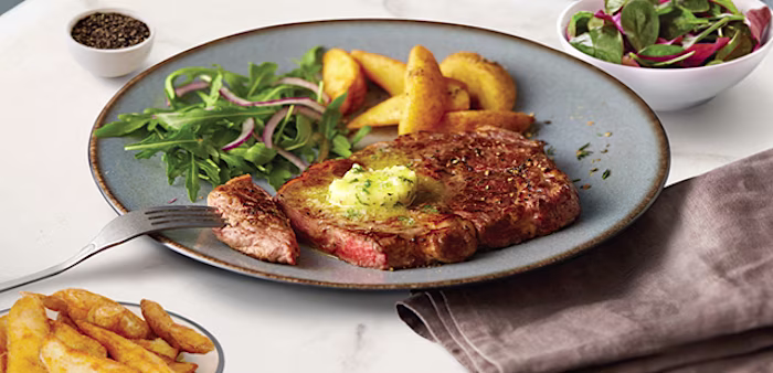 steak with chips salad and herby butter