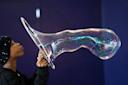 Person blowing bubble in New York Hall of Science