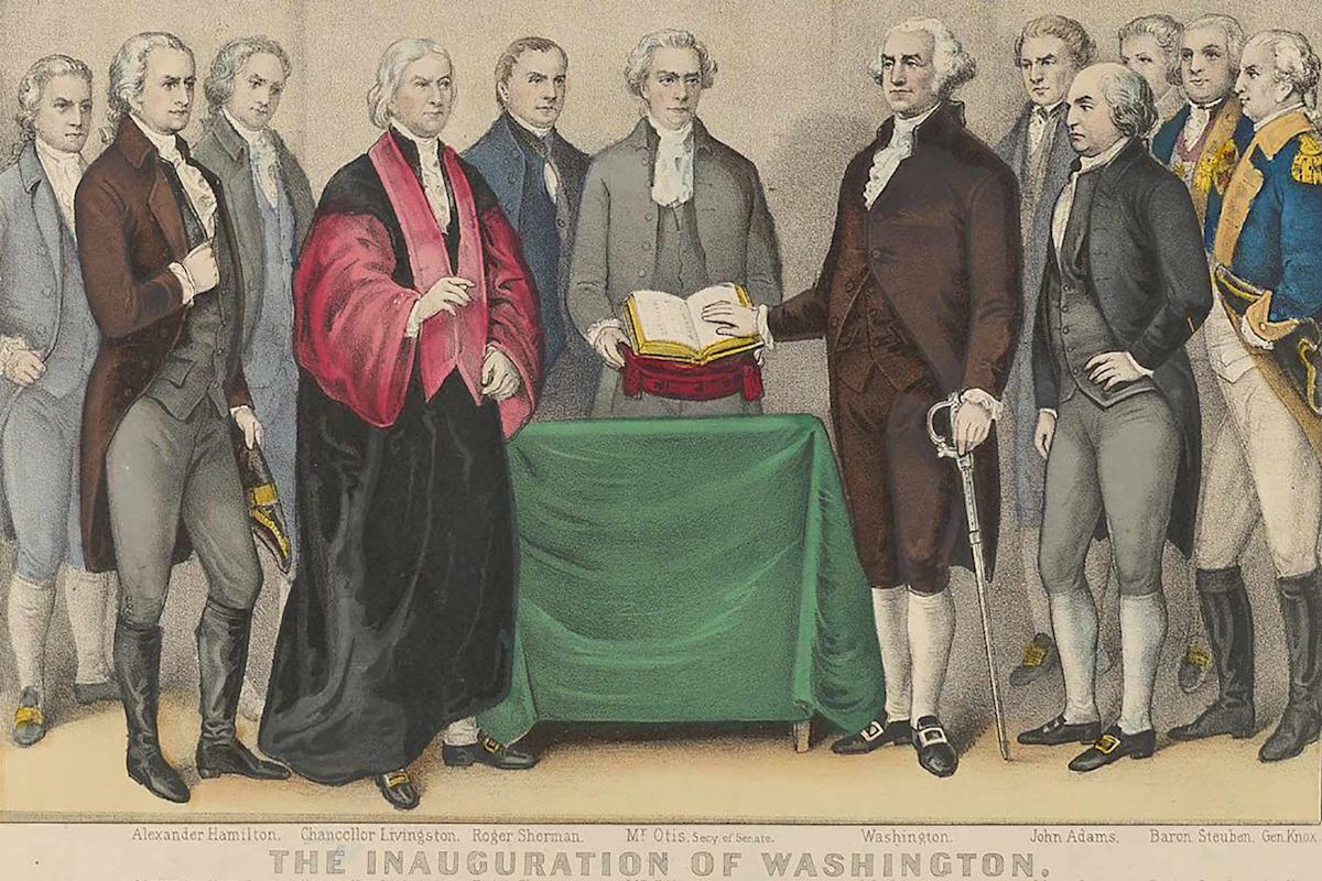 Historical illustration depicting a group of men in 18th-century attire gathered around a table with a green cloth. One man places his hand on a book, signifying a formal event. The caption reads "The Inauguration of Washington.