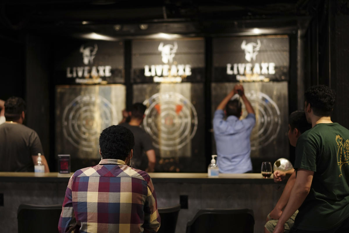 People throwing axes inside Live Axe