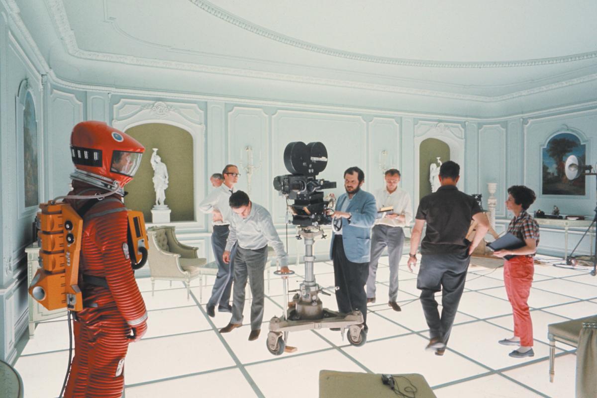 On the Hotel Room set of 2001: A SPACE ODYSSEY (1968, DIR. Stanley Kubrick). Kubrick is shown at the center behind the camera. Credit: Courtesy of Warner Bros.