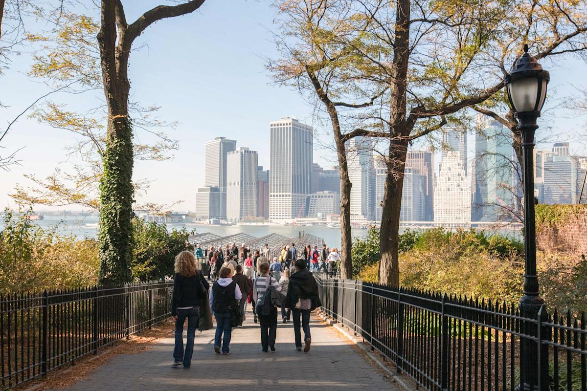 People walking in Brooklyn Heights promenade in Brooklyn, NYC