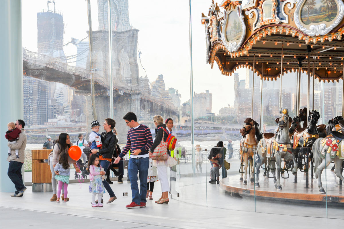 People and children at Jane's Carousel in DUMBO, NYC
