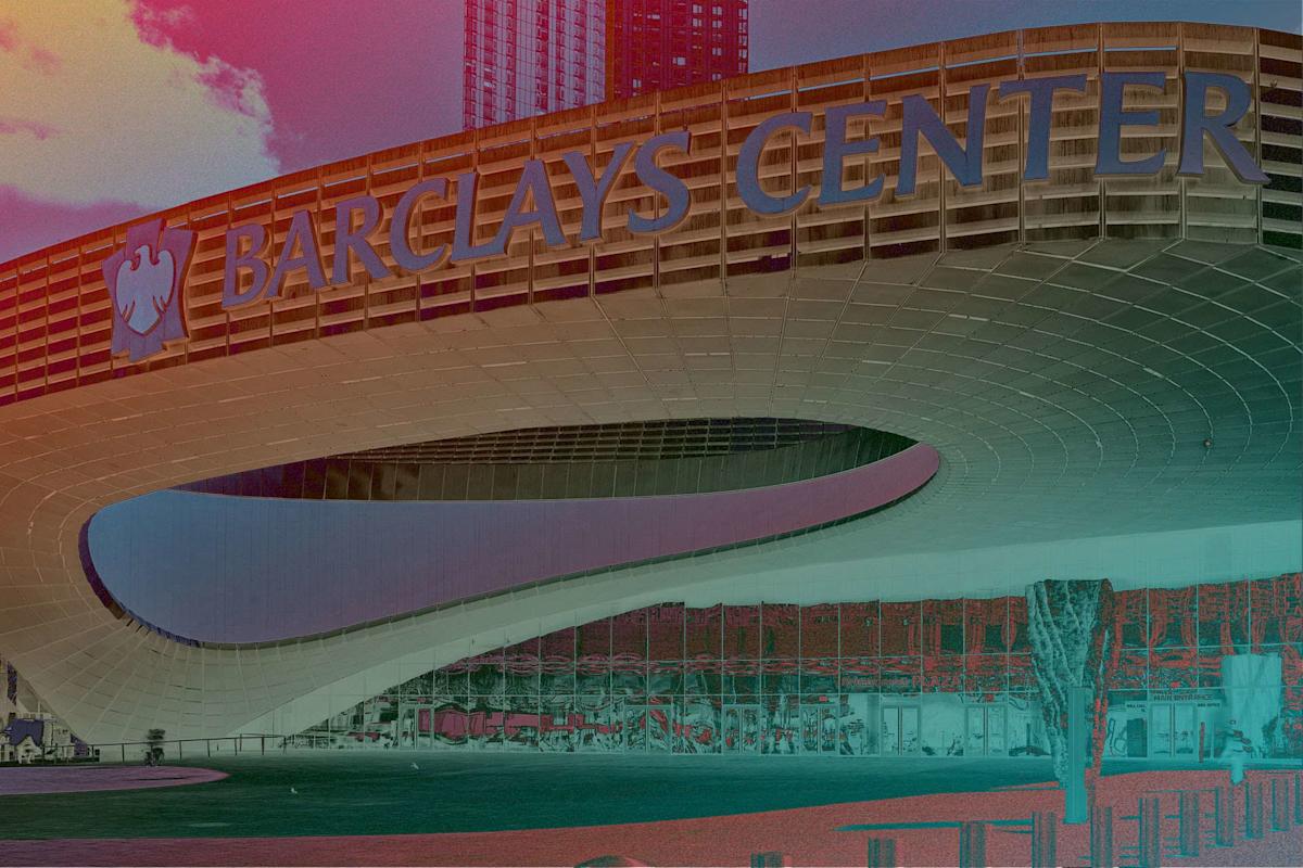 Barclays Center’s modern, curved exterior with large blue signage is shown under a partly cloudy sky, with a tall building visible in the background.