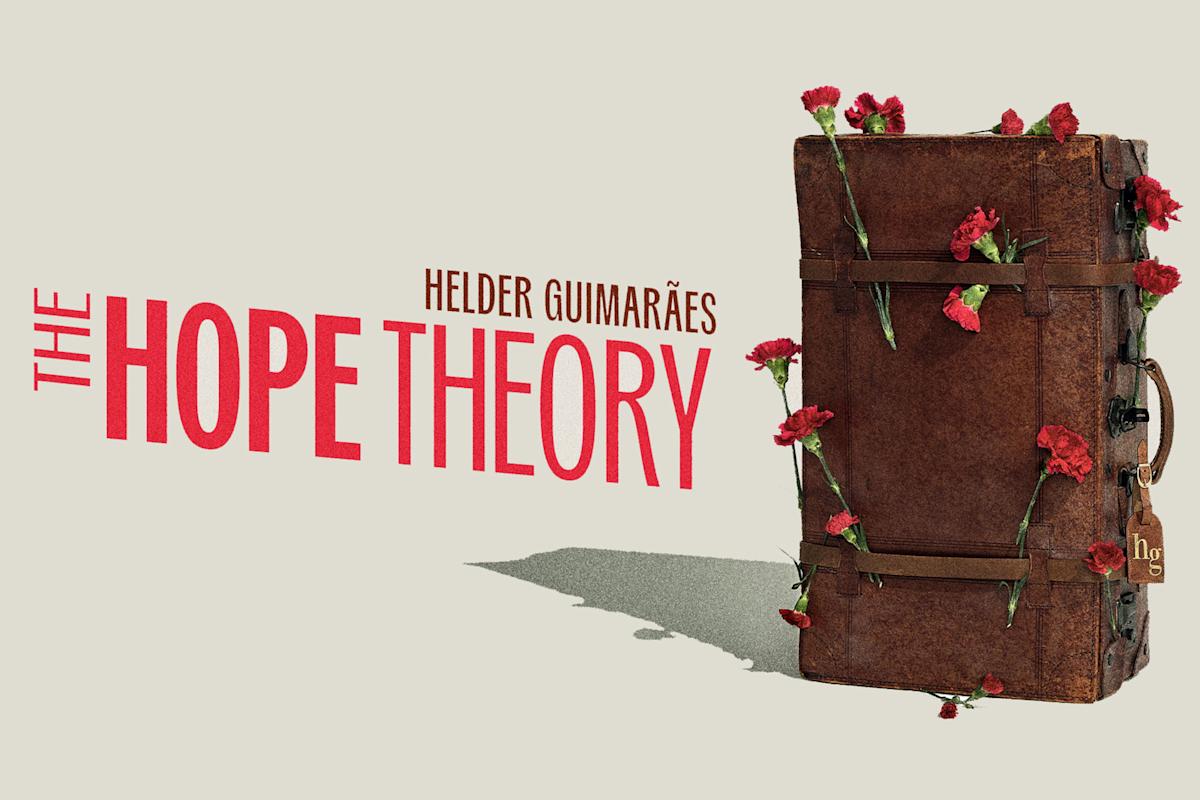 A vintage brown suitcase adorned with red carnations stands upright beside the text “THE HOPE THEORY” by Helder Guimarães.