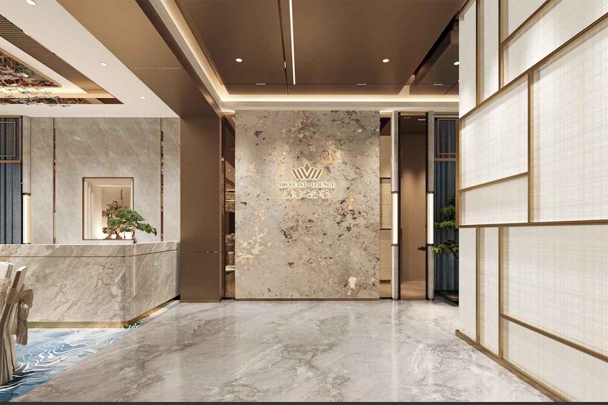 Elegant hotel lobby with marble walls and floors, gold accents, a reception desk on the left, decorative lighting, and a modern sign with Chinese and English text on the back wall. Bonsai plants add a natural touch.