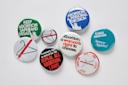 A collection of pro-choice and abortion rights buttons with slogans like “Keep abortion safe and legal,” “Abortion: a woman’s right to choose,” and images of coat hangers.