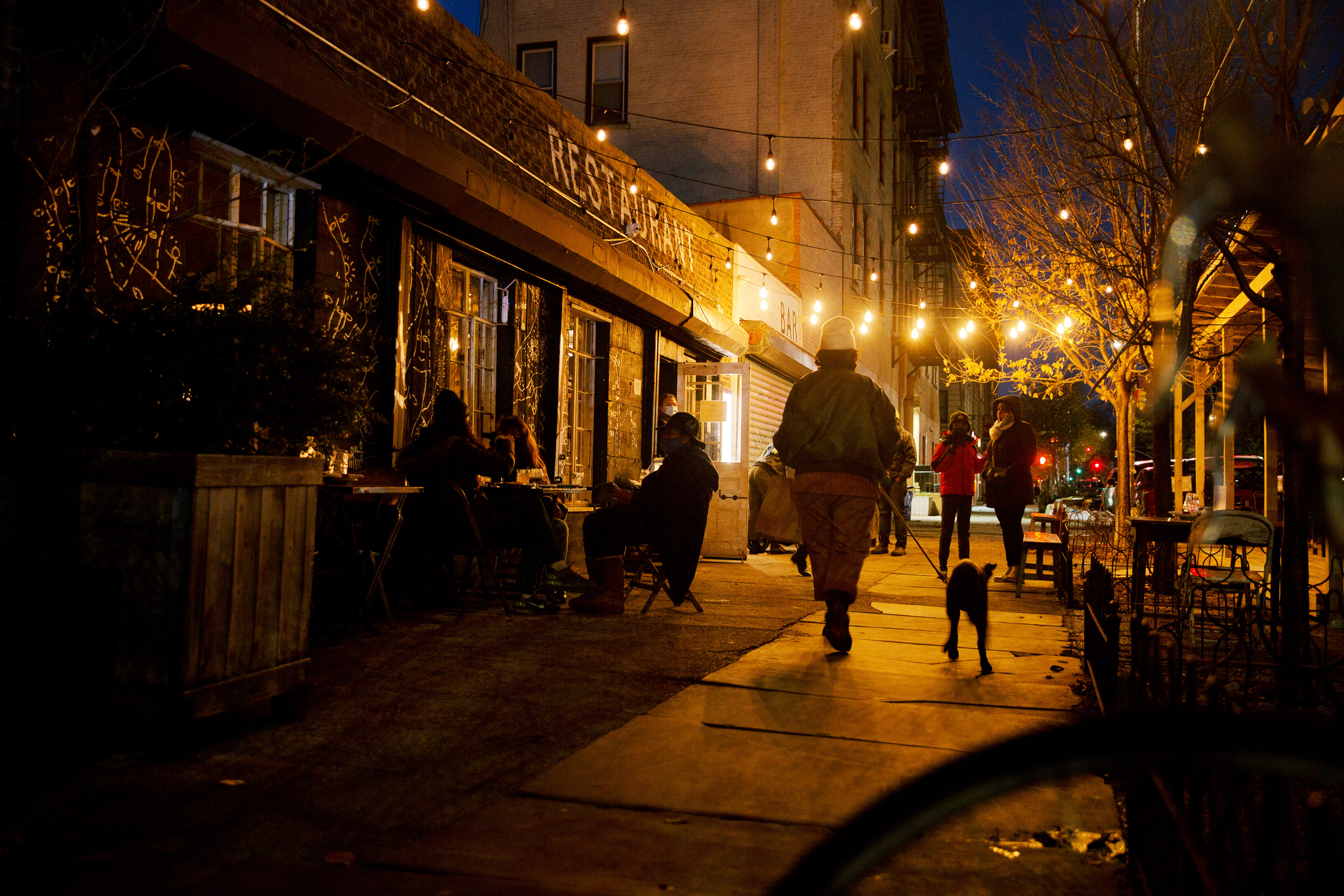 People walking down a street in Bed Stuy, Brooklyn at night