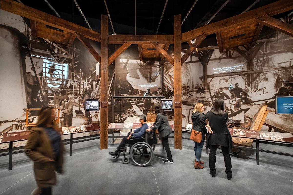 People watching an exhibit inside the Statue of Liberty Museum