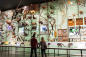 People looking at exhibit wall inside the American Museum of Natural History, in Manhattan