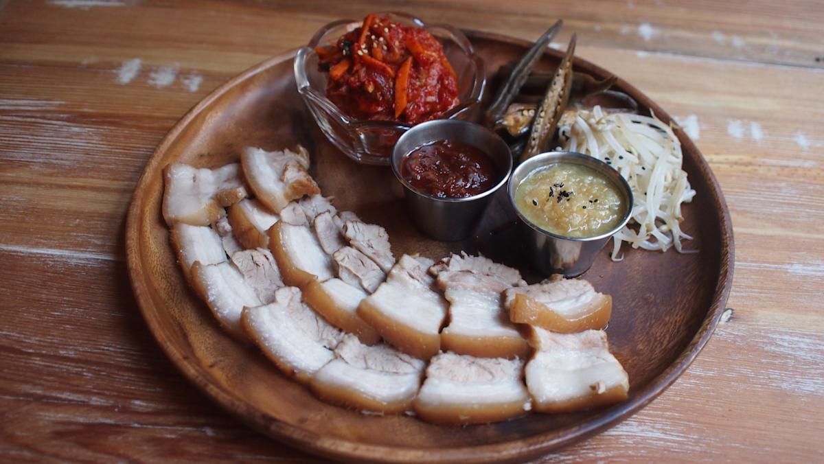 Porkbelly on plate at Her Name is Han, in Koreatown