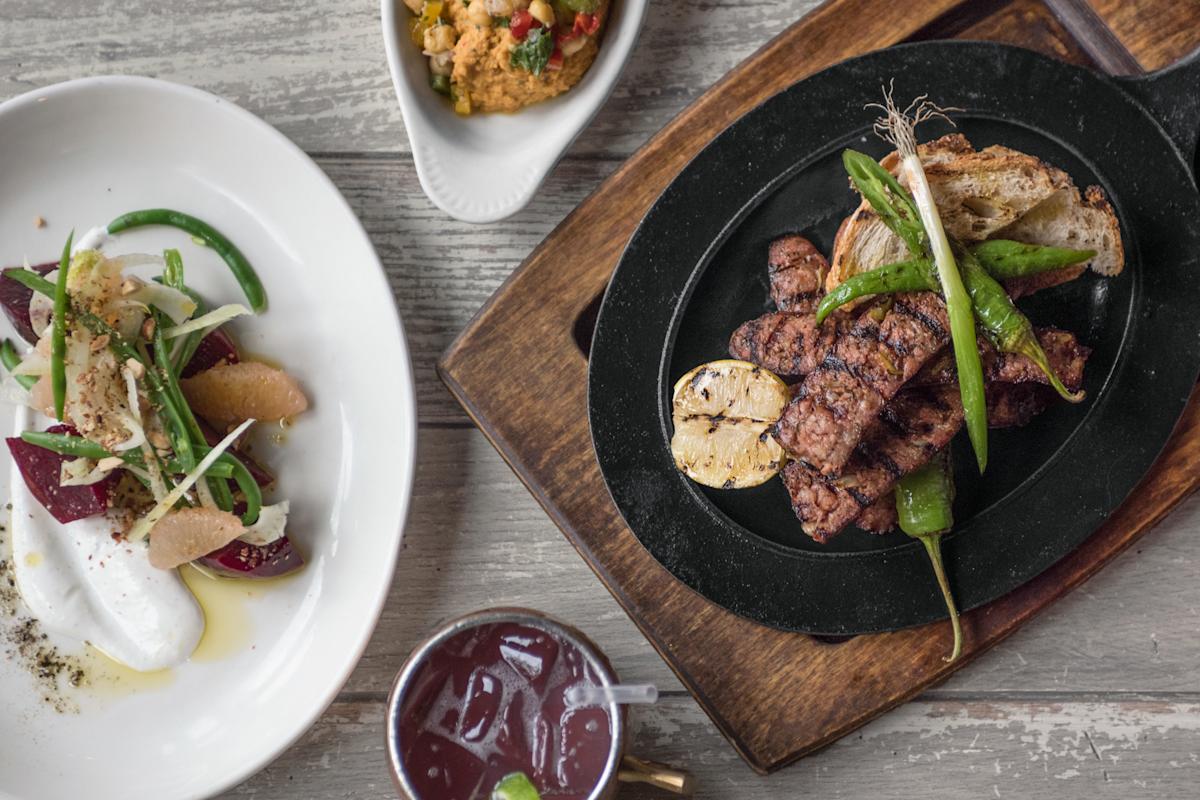 steak served in a skillet and delicious salad from MP Taverna in Astoria Queens