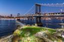 Manhattan Bridge Park at night with a view of the Manhattan skyline