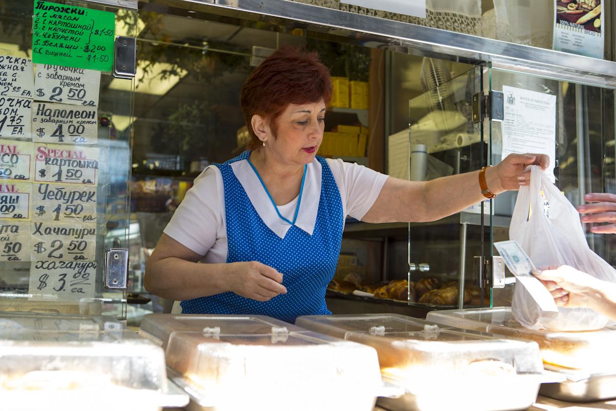 serving food at Gold Label International Food in Brighton Beach