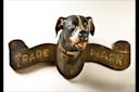 Dog Trade Sign
Arast unidenafied
Made for A.L. Kieselbach Paint Store
Brooklyn, New York
c. 1898
Paint on wood with leather and metal collar and glass eyes 16 x 38 x 17&quot;
Collecaon of Penny and Allan Katz
