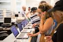 Women reading at Heiskell Library, on a laptop with headphones in Manhattan, New York City